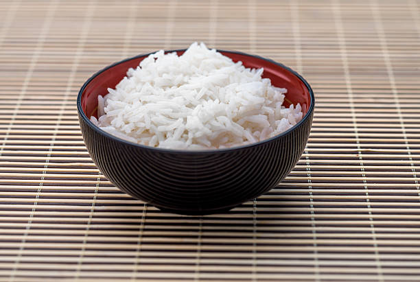 Bowl of rice, Asian Cuisine High angle view closeup of a bowl of rice  on bamboo basmati rice stock pictures, royalty-free photos & images