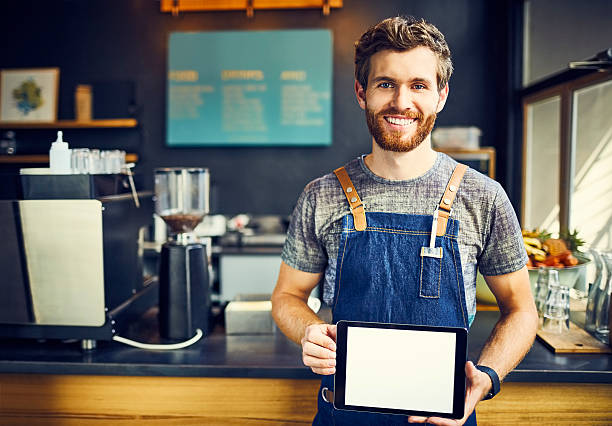 istock Smiling barista holding blank digital tablet 544600230