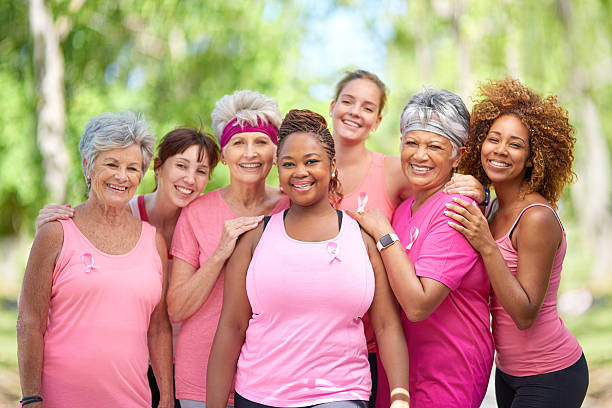 Join us in helping to raise breast cancer awareness Portrait of a group of woman taking part in a fitness event to raise awareness for breast cancer breast cancer stock pictures, royalty-free photos & images