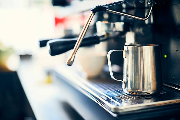istock Close-up of milk jug on coffee machine at cafe 544602468