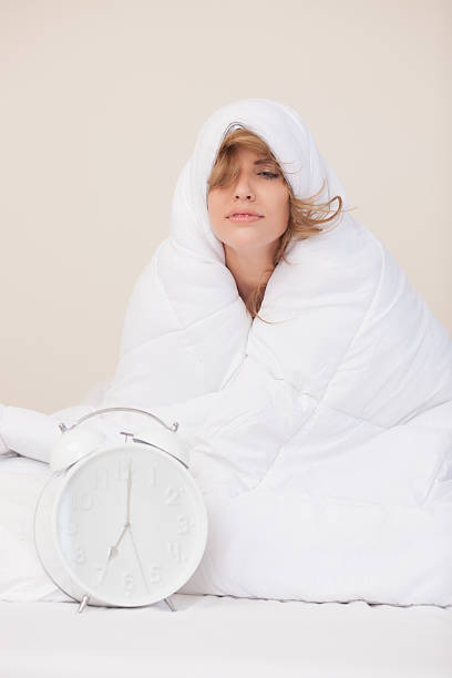 woman wrapped up on warm blanket. - unwillingness imagens e fotografias de stock