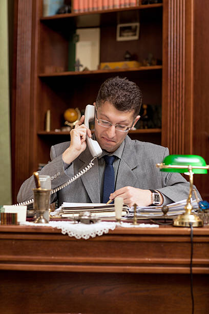 istock middle age businessman sitting in the office and using phone 544602898