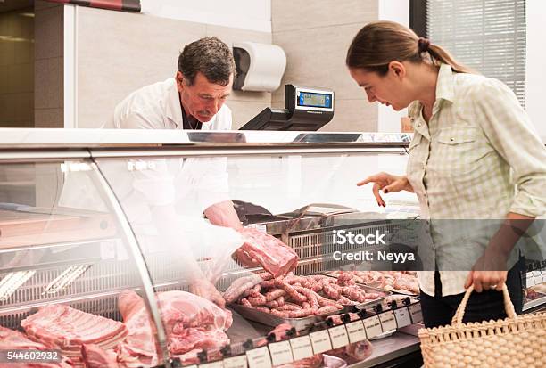 Woman Buying Meat At The Butcher Shop Stock Photo - Download Image Now - Butcher's Shop, Butcher, Delicatessen