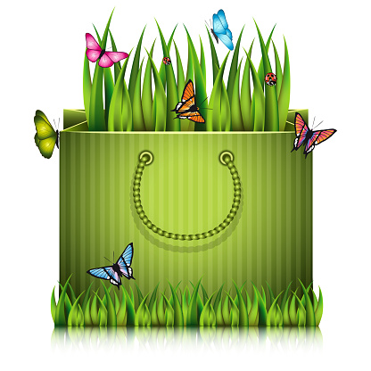 Paper shopping bag with fragment of grass on the lawn peace with butterflies.