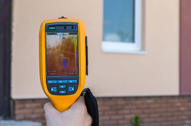istock Man inspect house window with thermal imaging camera 544603848