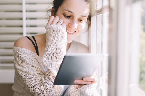 istock Woman at home reading an e-book 544604210