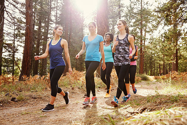 istock Group of women runners walking in a forest talking 544604754