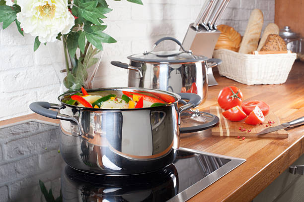 istock pan on the stove with vegetables in kitchen interior 544652496