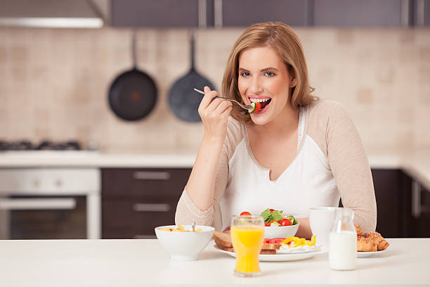 istock Beautiful woman eating breakfast. 544653206