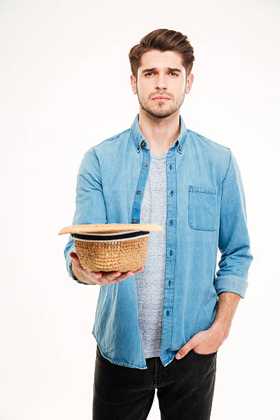 istock Sad poor young man holding hat and asking for money 544653354