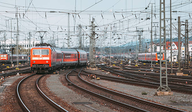 istock Railway station with modern red commuter train at sunset 544654836