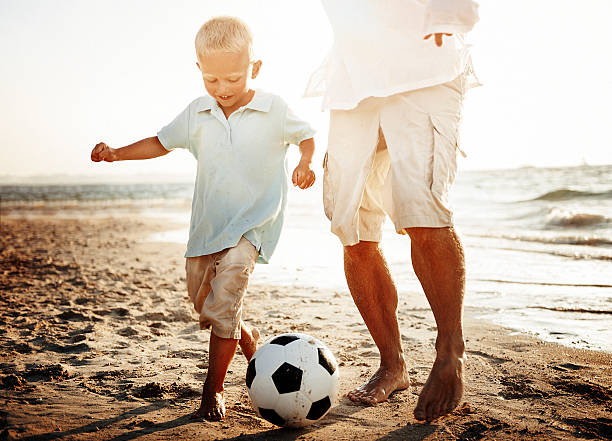 istock Soccer Father Son Fun Beach Concept 544655220