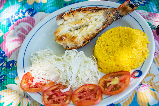 Grilled lobster with rice and salad on a beach restaurant in Cuba