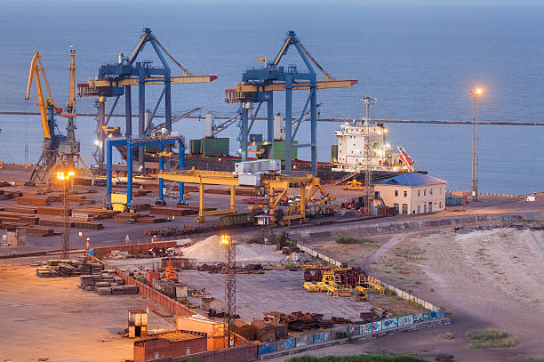 Sea commercial port at night in Mariupol Sea commercial port at night in Mariupol, Ukraine. Industrial view. Cargo freight ship with working cranes bridge in sea port at twilight. Cargo port, logistic mariupol stock pictures, royalty-free photos & images