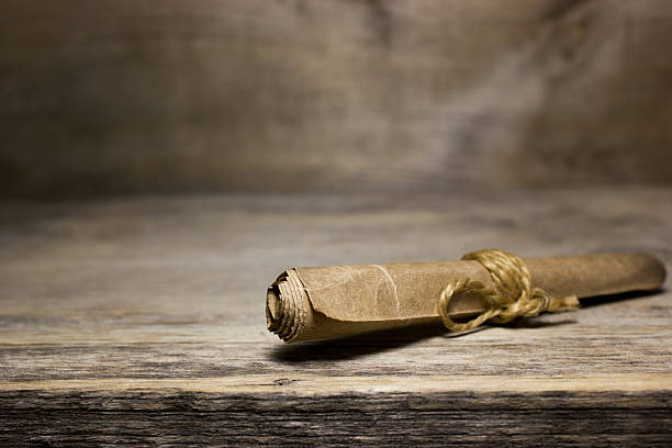 istock Paper scroll on the wooden table. 544661578