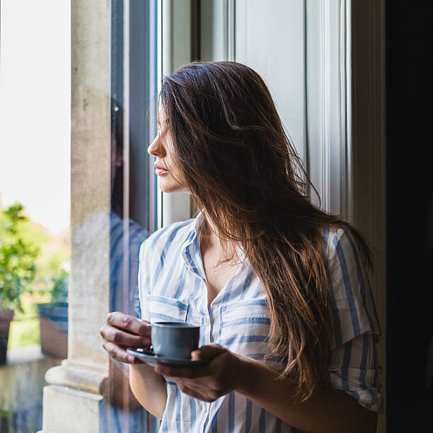 istock Woman drinks coffee at home 544663566