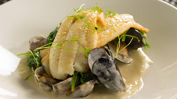 istock Lemon sole with mussels, clams & spinach 544665584
