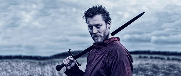 istock Strong warrior stands on the battlefield with a sword 544667704