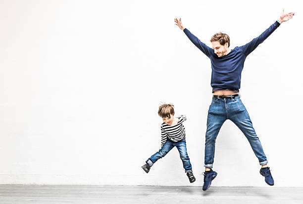 Father and Son playing in their living room.