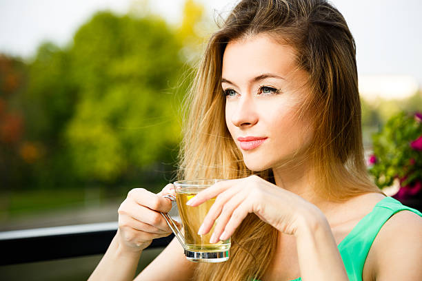 Young Woman Drinking Green Tea Outdoors stock photo