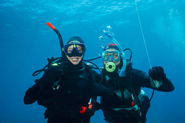 istock Scuba diving    Underwater scene with two scuba diver in blue 544669624