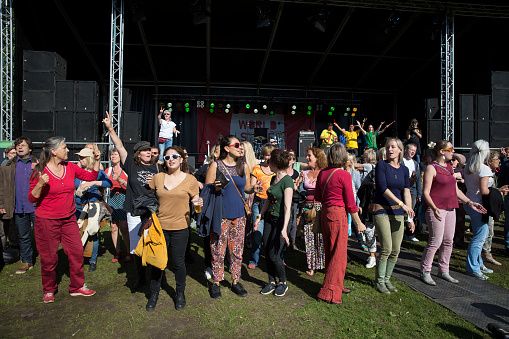Amsterdam, The Netherlands - July 3, 2016: People performing a music and singing flashmob at Amsterdam Roots Open Air, free public cultural festival held in Oosterpark