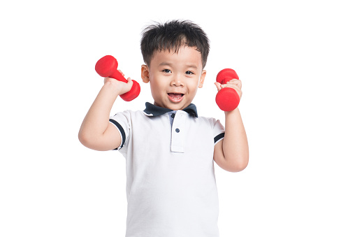 Cute little boy lifting weights