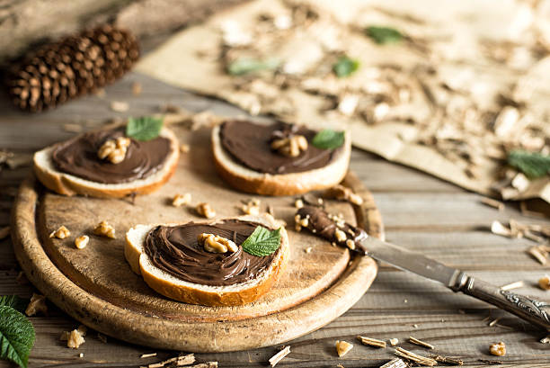 istock Slices of bread with chocolate cream nuts and knife. 544672744