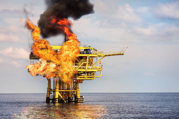 Offshore Oil and Gas Fire Case or Emergency Case Offshore Oil and Gas Fire Case or Emergency Case, Firefighter Operation to Control Fire on Oil and Gas Production Platform, Offshore Worst Case and can't control fire, Danger of Oil and Gas Industry. demobilization photos stock pictures, royalty-free photos & images