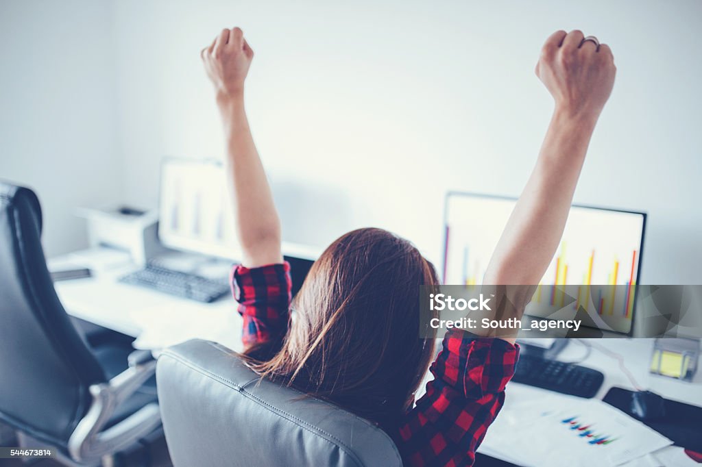 She did it! Winning, achievement concept - woman from the back with raised hands Finishing Stock Photo