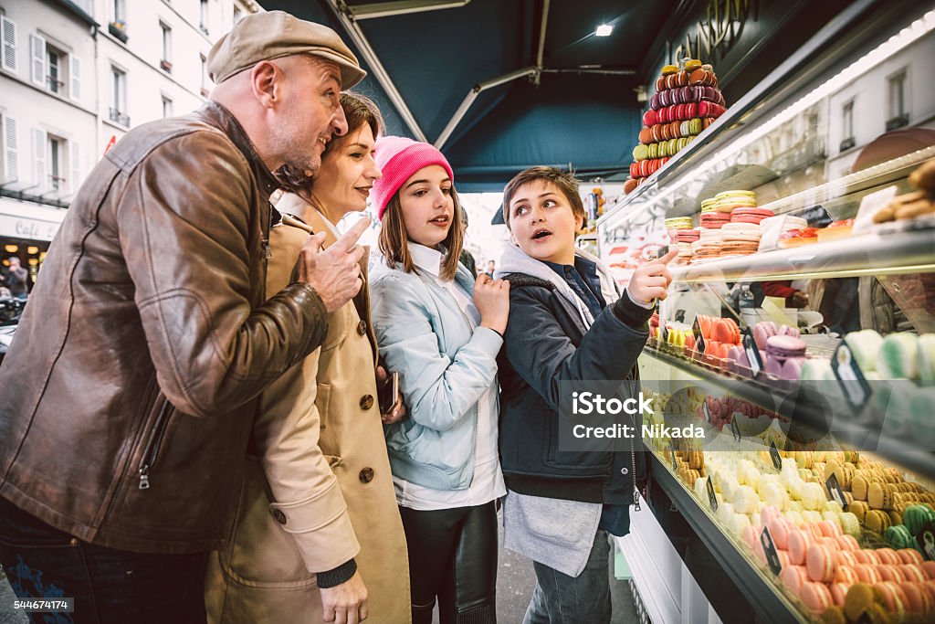 French Macarons shopping in Paris, France french family standing at paris macarons stall Paris - France Stock Photo