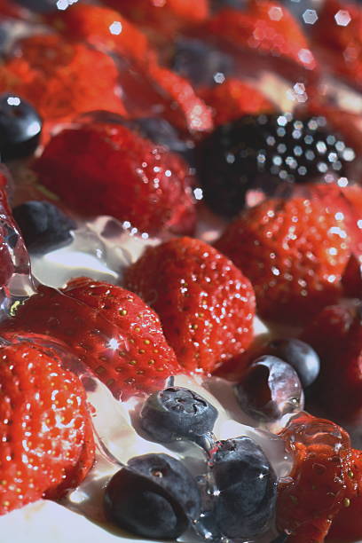 Strawberries, blueberries, blackberries and raspberries on cream, which mades isolated stock photo