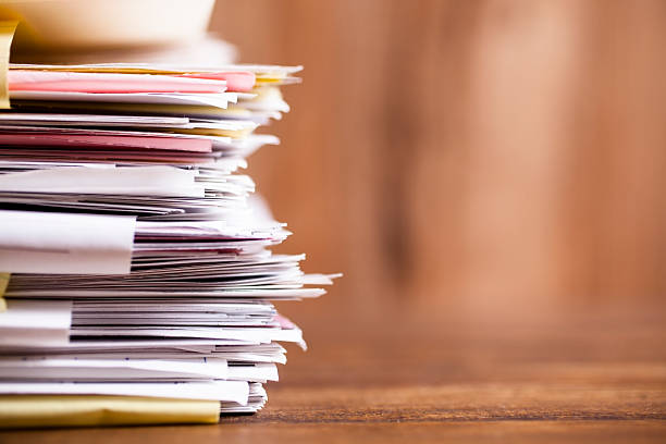 Large stack of files, paperwork. Close-up. Desk, office. Nobody.