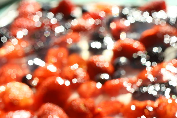 Blurred photo of strawberries, blueberries, blackberries and raspberries on cream stock photo