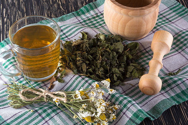istock mortar and pestle with herbal tea. 544677738