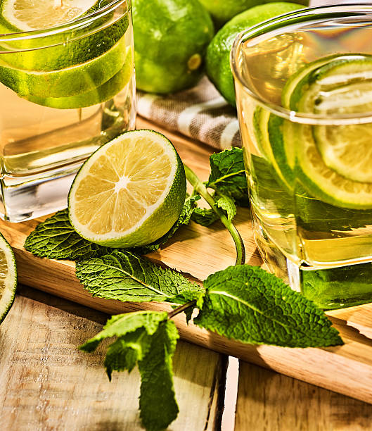 istock Glasses with green transparent lime drink and mint napkin. 544683072