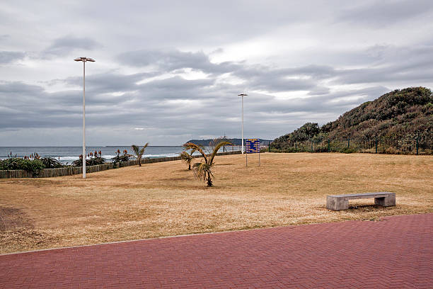 istock Paved Walkway Dry Winter Grass Verge Ocean and Skyline 544684638