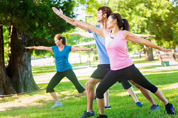 istock Yoga instructor helps woman with warrior 2 pose 544686136