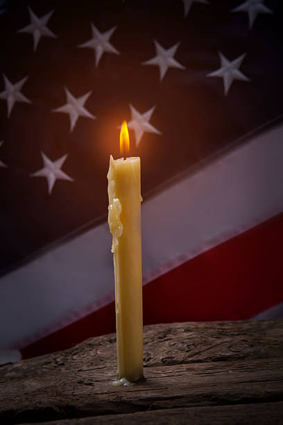 istock Burning candle and american flag. 544686296