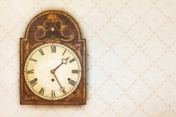 istock Vintage clock on a wall with retro wallpaper 544686318