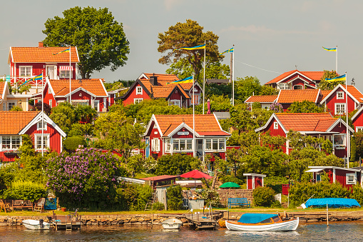 Typical red swedish wooden houses with boats in the city of Karlskrona