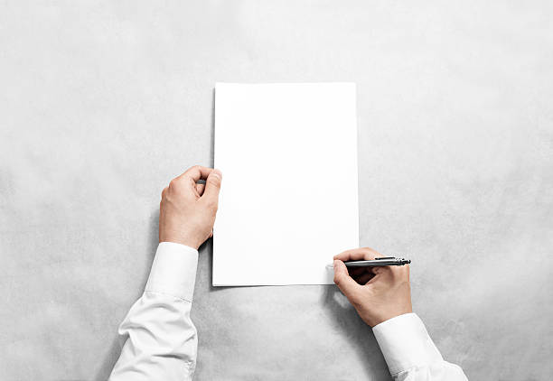 istock Hand hold blank contract mockup and signing it 544714076