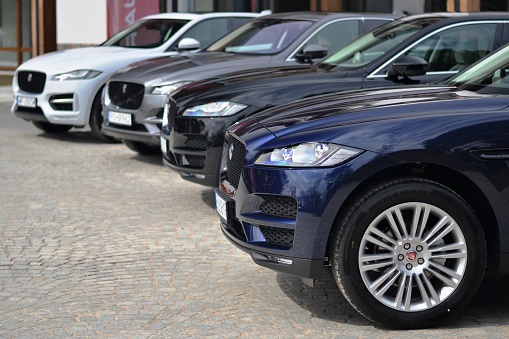 Jedwabno, Poland, April 11th, 2016: Jaguar F-Pace vehicles stopped on the parking before the test drives. The monocoque architecture and car body of this vehicles are constructed with aluminium. The F-Pace is the first SUV from Jaguar brand.
