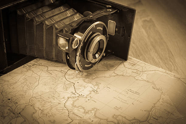 Old photo camera and paper map. Antique photo