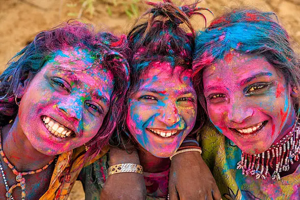 Photo of Group of happy Indian girls playing holi, desert village, India