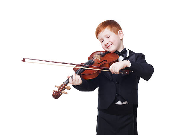 istock Cute redhead child boy plays violin isolated at white background 544719080