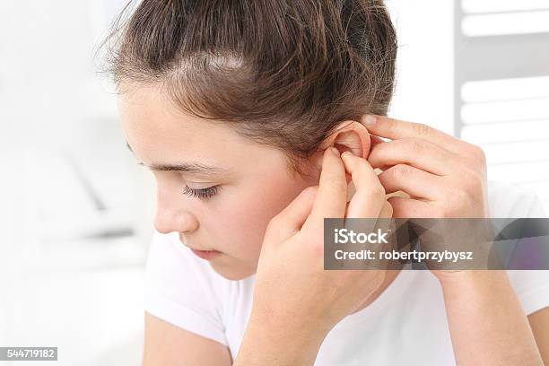 Child With A Hearing Aid Stock Photo - Download Image Now - Hearing Aid, Assistive Technology, Deafness