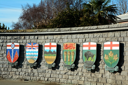 Victoria BC,Canada,March 3rd 2015.Provincial coats of arms for BC,Alberta,Saskatchewan,Manitoba,Ontario and Yukon Territory on a rock wall in Victoria.
