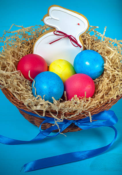 istock Easter eggs in a nest and gingerbread on blue background 544721434