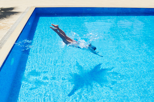 Ripple Blue Water Surface In Swimming Pool With Reflection Of Natural Sun Light